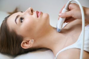 Young woman undergoing a thyroid ultrasound procedure